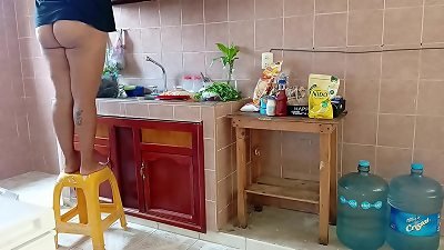 obese stepmother washes and cleans the kitchen